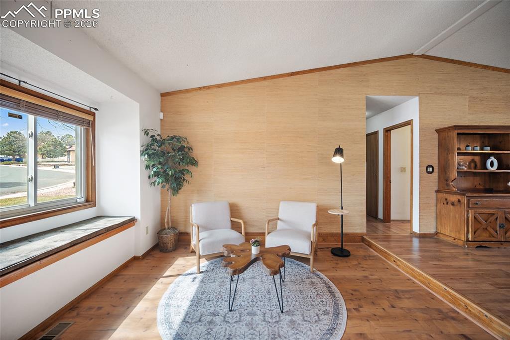 Image 4 of 40: Sitting room with hardwood / wood-style flooring and baseboards