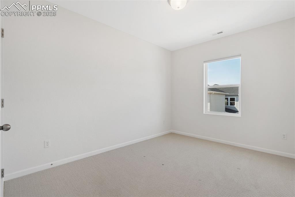 Image 25 of 42: 3rd bedroom on upper level