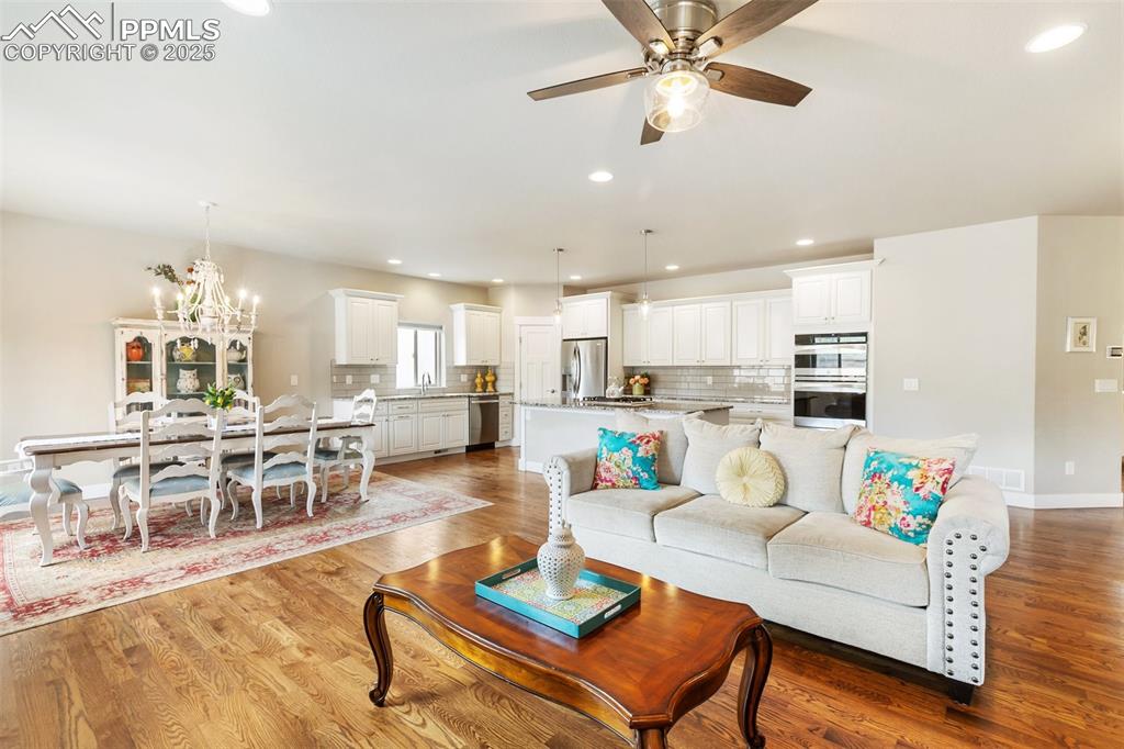 Image 3 of 44: Gorgeous great room with hardwood floors and abundant natural light!