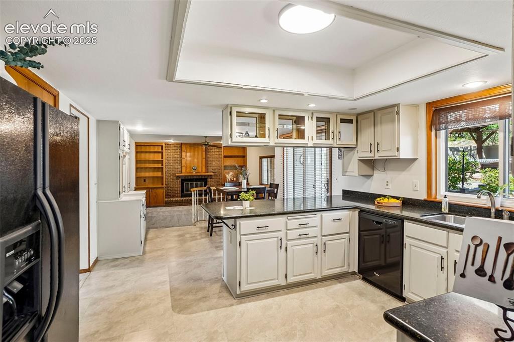 Image 10 of 48: Kitchen opens to eat-in area with walk-out to deck.