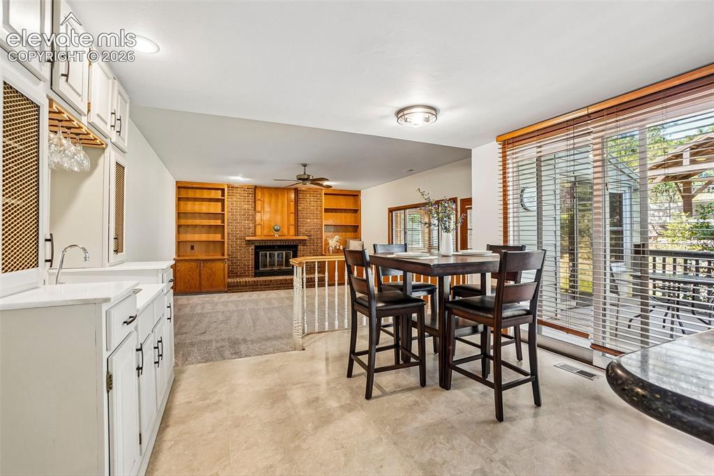 Image 13 of 48: This less formal eating area has a walk-out to the back deck and there is a