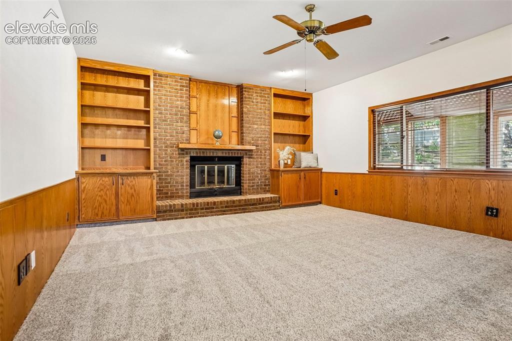 Image 15 of 48: Built-ins and a gas fireplace are the focal points of this large family roo