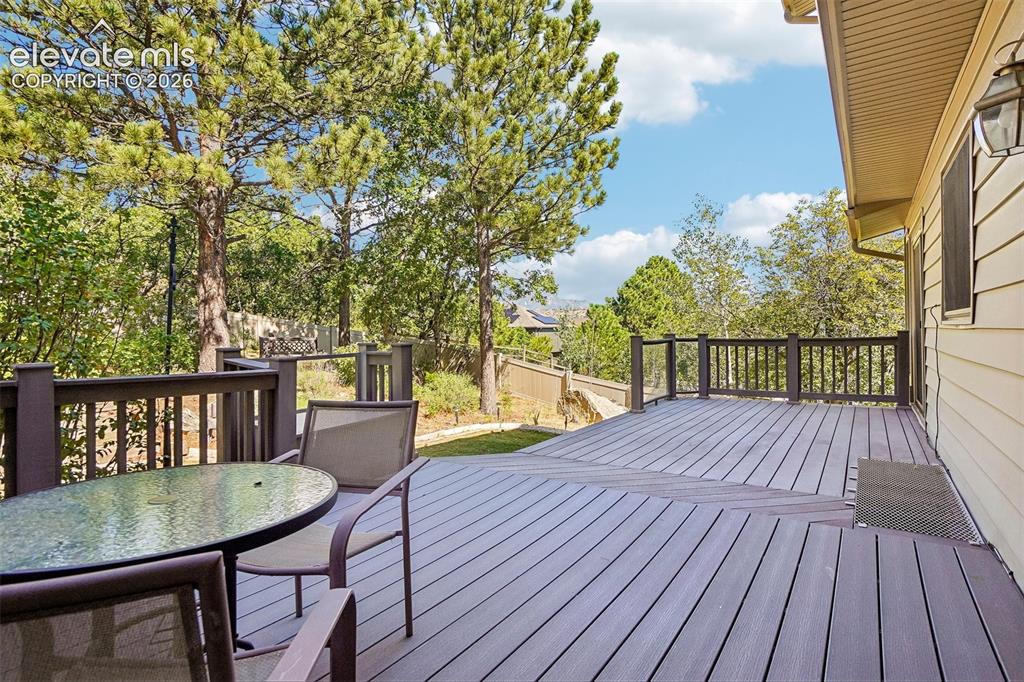 Image 17 of 48: Large back deck with views of the mountains beyond.