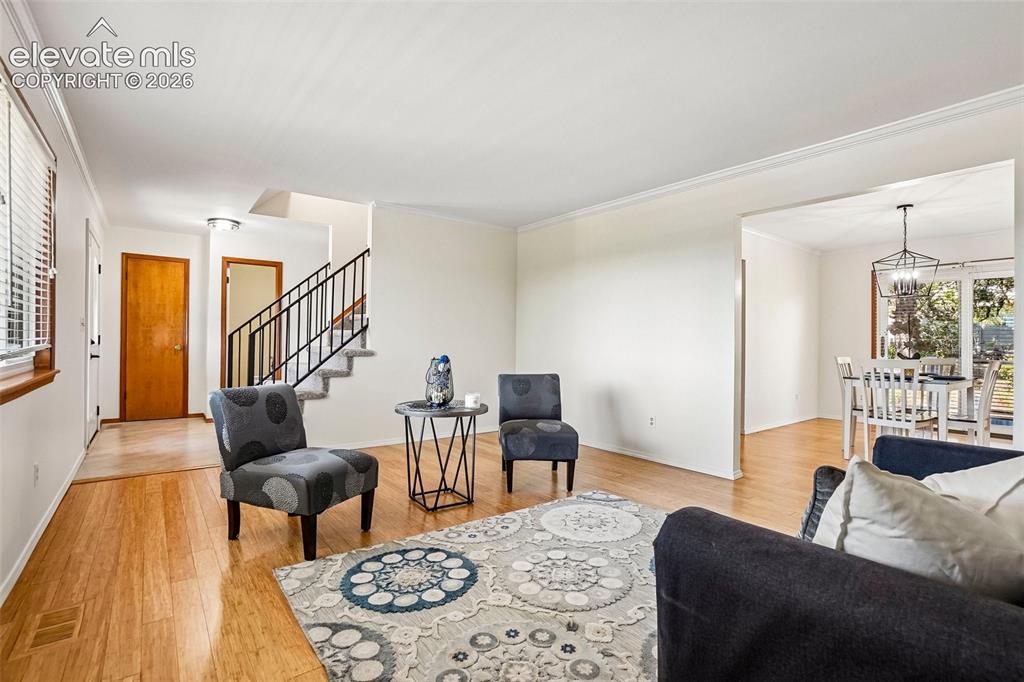 Image 6 of 48: Living room is bathed in natural light and open to formal dining space.