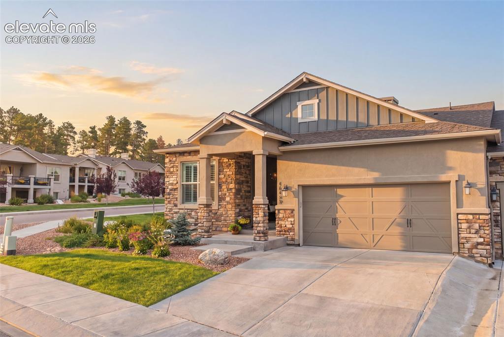 Caption: Stucco and stone facade with board-and-batten accent siding.