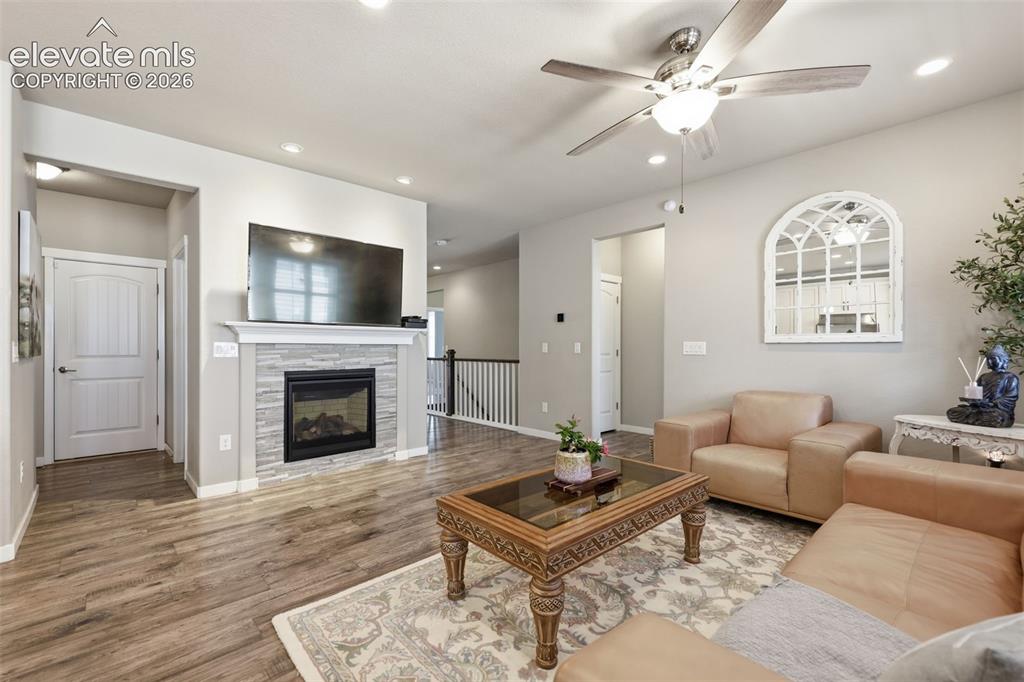 Image 13 of 43: Light brown luxury vinyl plank flooring, recessed lighting, ceiling fan, co