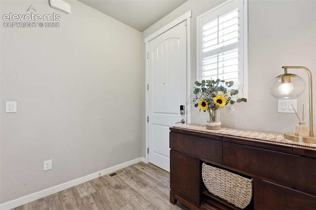 Image 14 of 43: Entry featuring light brown luxury vinyl plank flooring throughout the main