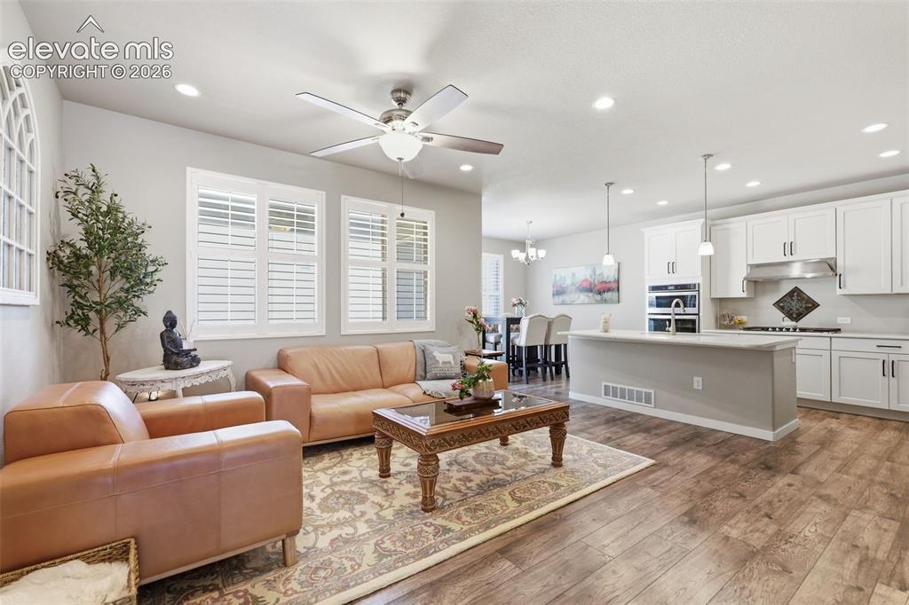 Image 2 of 43: Open concept floor plan light brown luxury vinyl plank flooring, recessed l