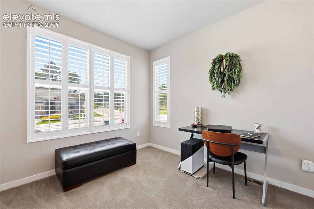 Image 22 of 43: Neutral wall tones, plantation shutters, recessed lighting, and carpet floo