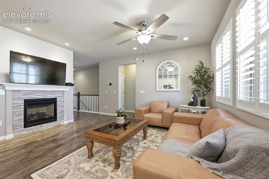 Image 3 of 43: Living area featuring light brown luxury vinyl plank flooring, a fireplace 