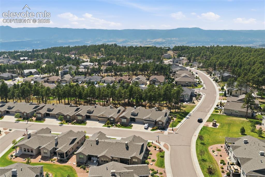 Image 41 of 43: Residential community featuring paved streets, mature trees, and mountainou