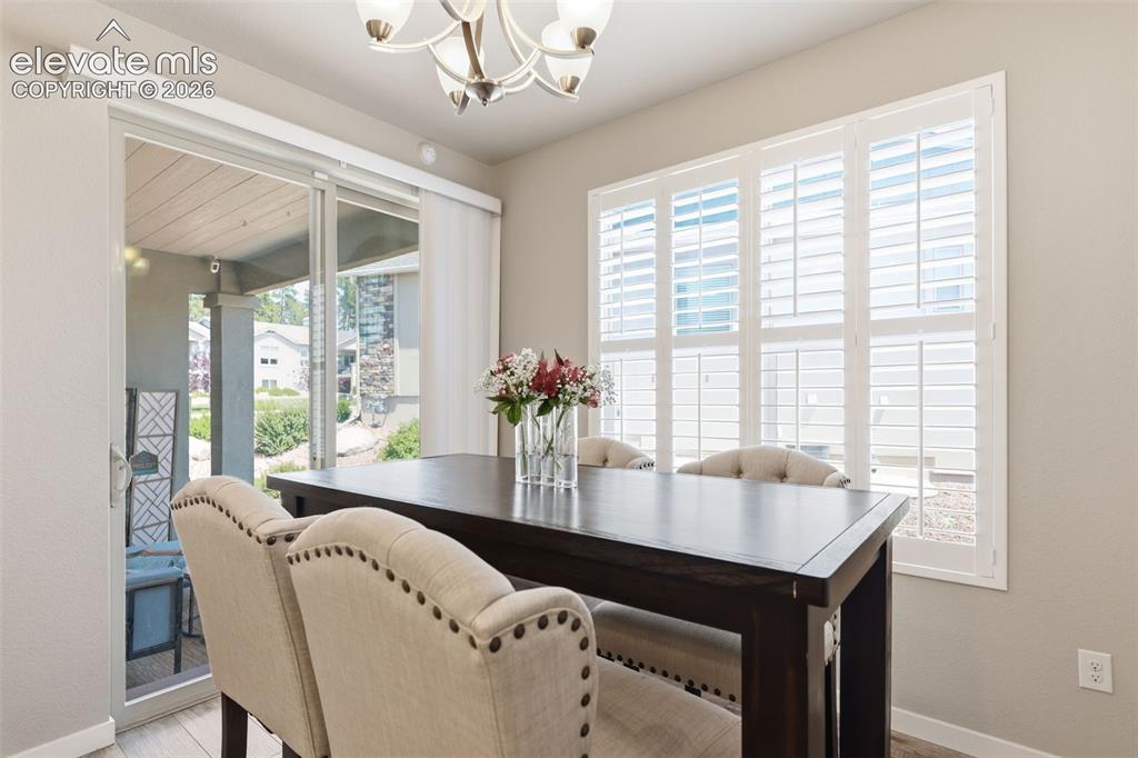 Image 9 of 43: Recessed lighting, sliding glass door, plantation shutters, and light  brow