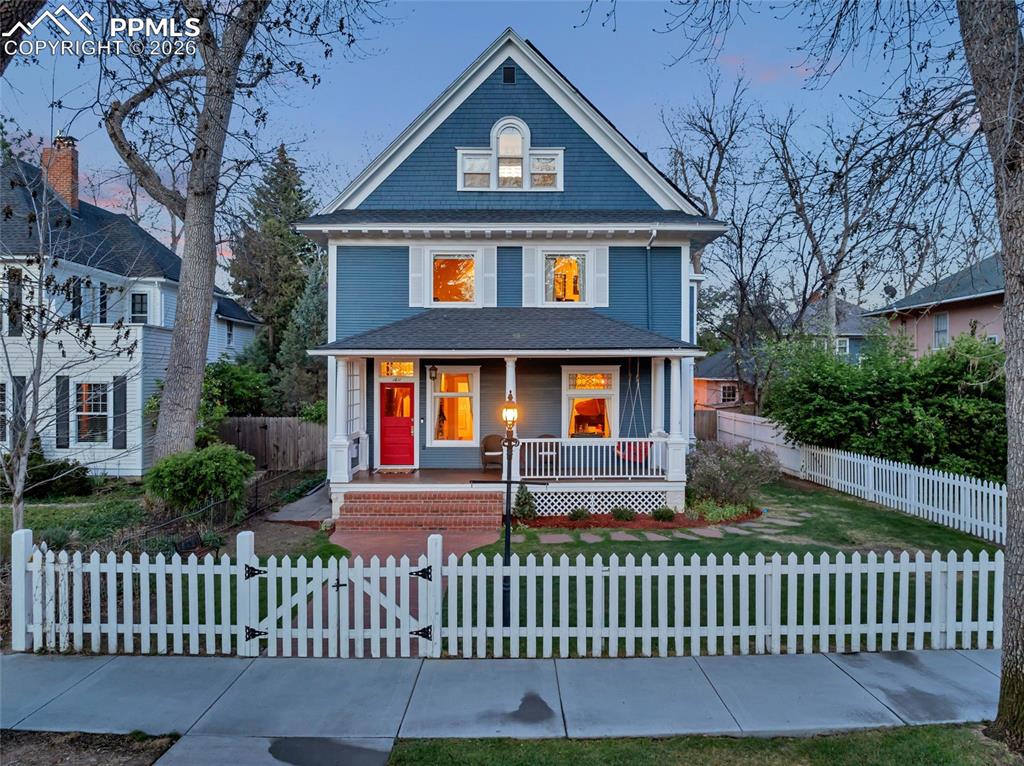 Image 2 of 50: Historic home on tree lined street