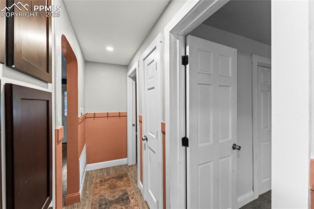 Image 11 of 26: Hallway featuring dark wood-type flooring and recessed lighting