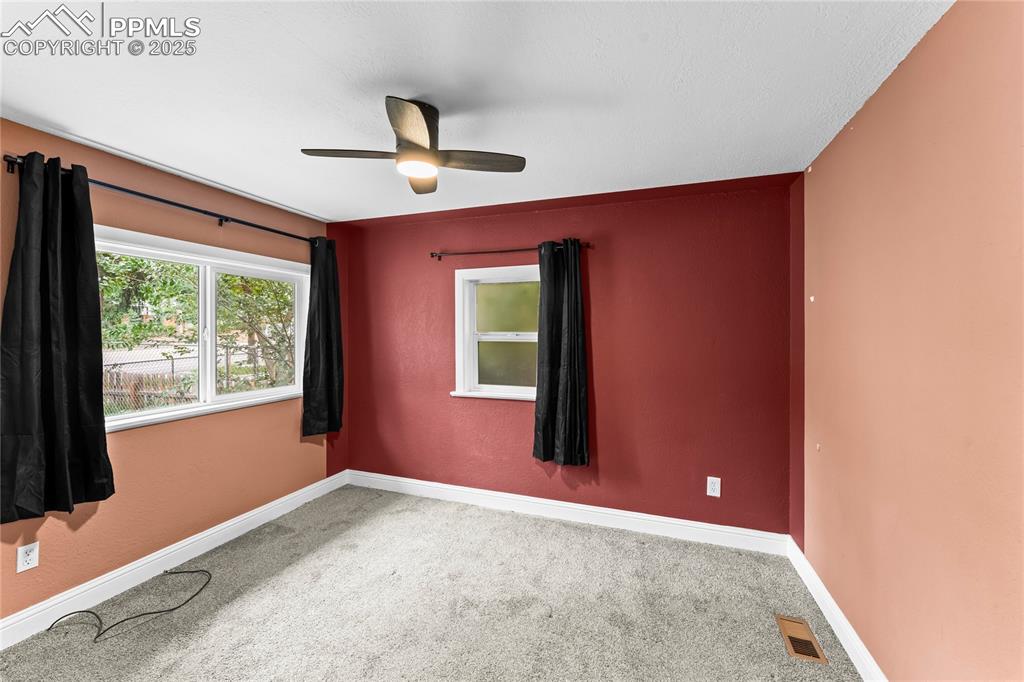 Image 12 of 26: Empty room featuring carpet flooring and ceiling fan