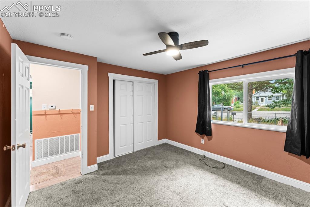 Image 13 of 26: Unfurnished bedroom featuring carpet floors, a closet, and a ceiling fan