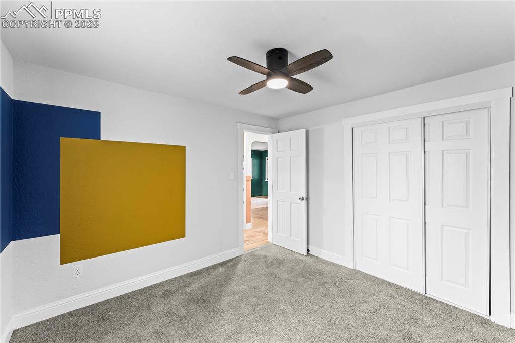 Image 16 of 26: Unfurnished bedroom featuring carpet, a closet, and a ceiling fan