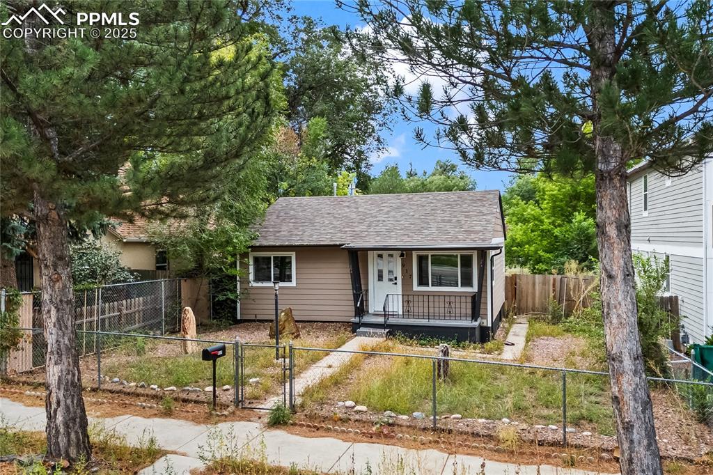 Image 2 of 26: Bungalow-style house featuring a gate, a fenced front yard, roof with shing
