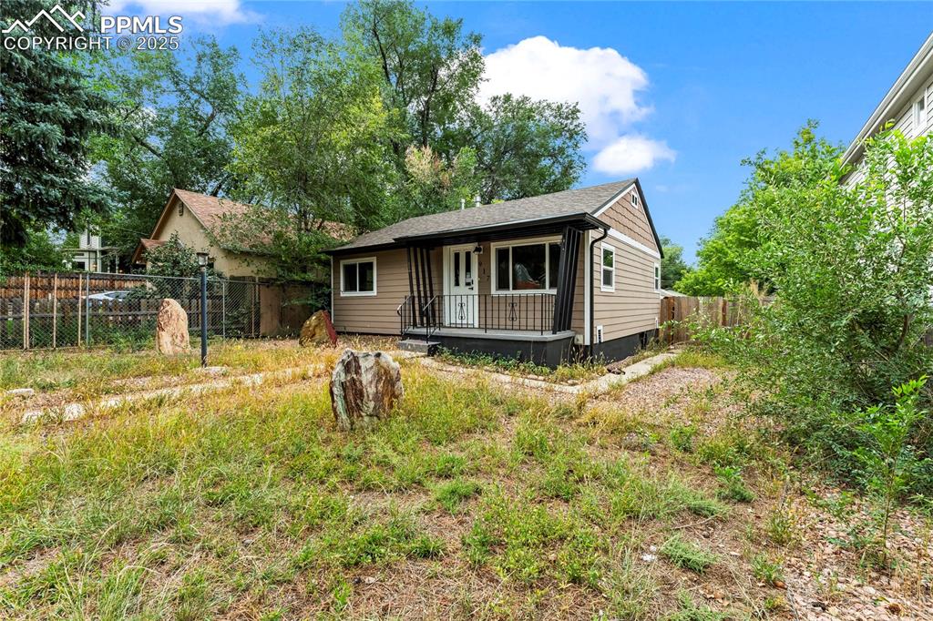 Image 3 of 26: Back of property featuring a porch and roof with shingles