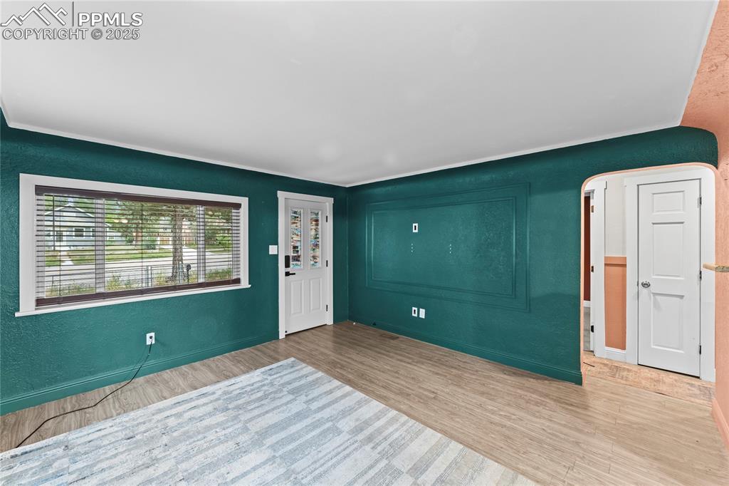Image 6 of 26: Foyer entrance featuring a textured wall, wood finished floors, and arched