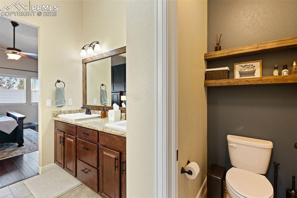 Image 18 of 31: Full bath featuring connected bathroom, a ceiling fan, and double vanity