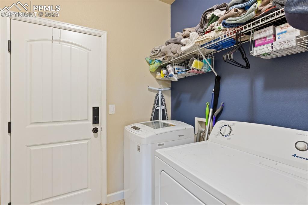 Image 23 of 31: Washroom featuring separate washer and dryer and baseboards