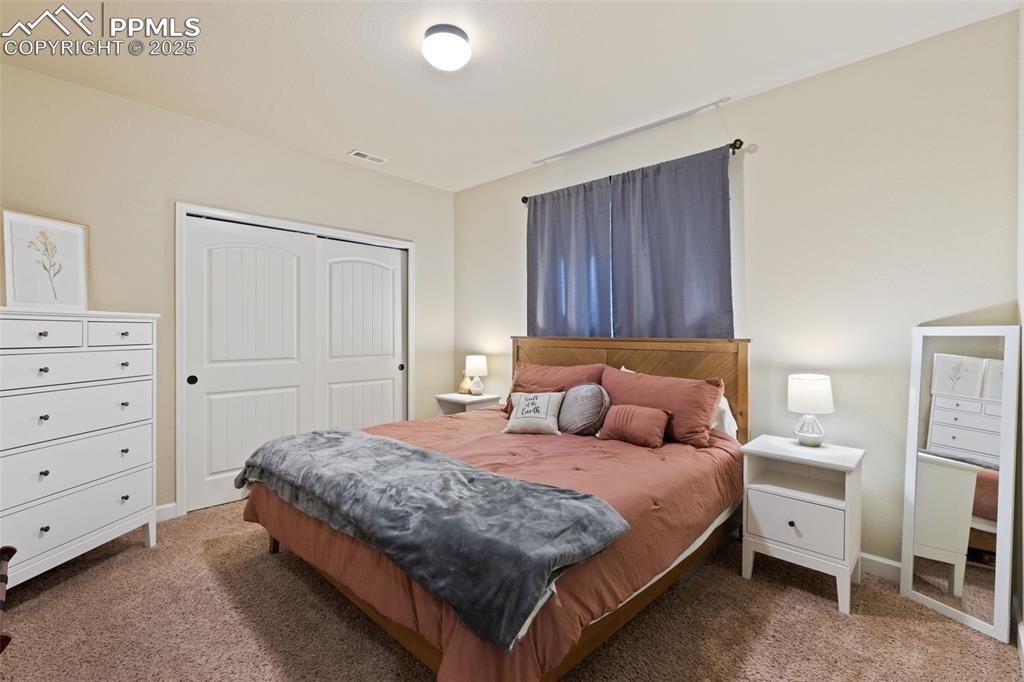 Image 28 of 31: Carpeted bedroom with a closet