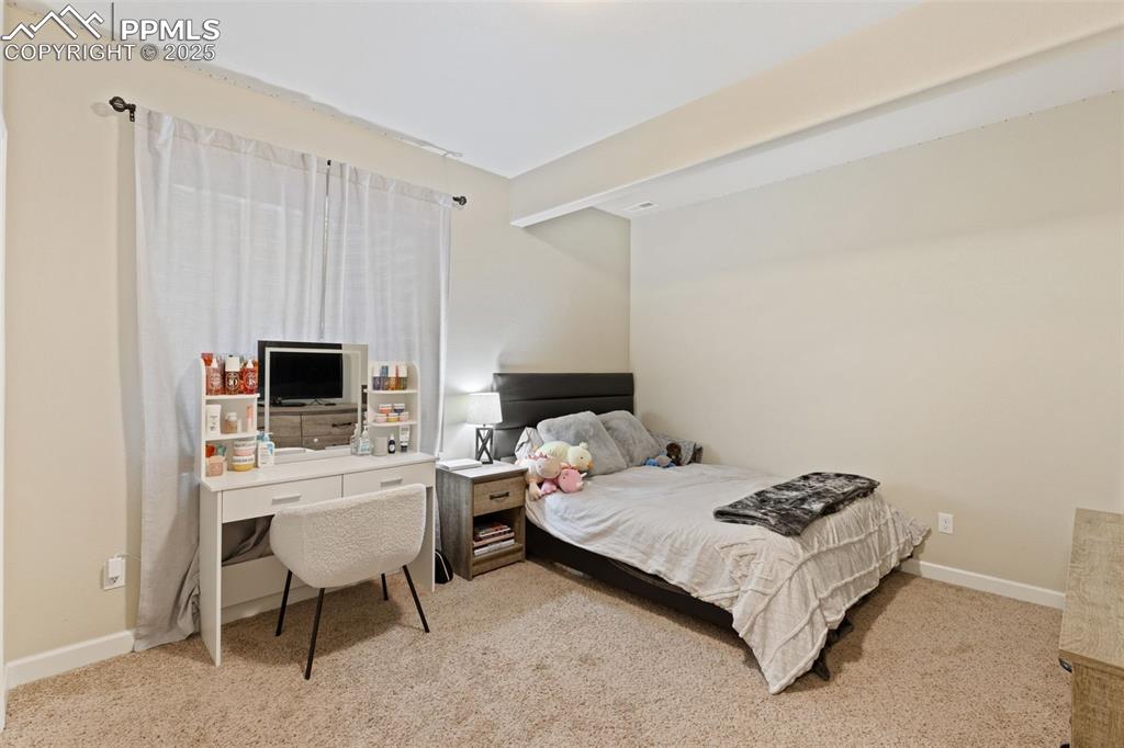 Image 29 of 31: Bedroom featuring light colored carpet and baseboards