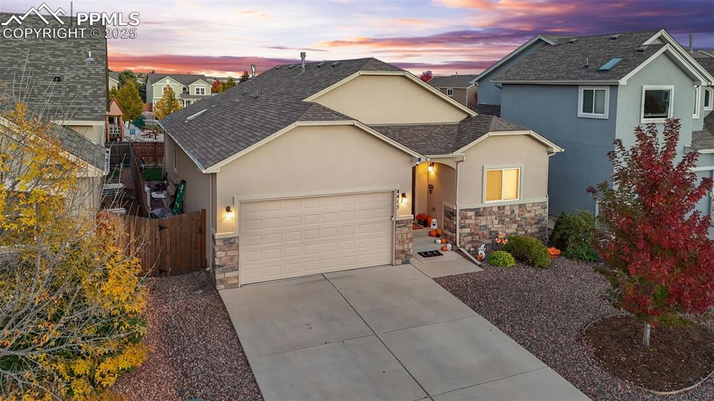 Image 3 of 31: Traditional-style house with roof with shingles, stucco siding, stone sidin