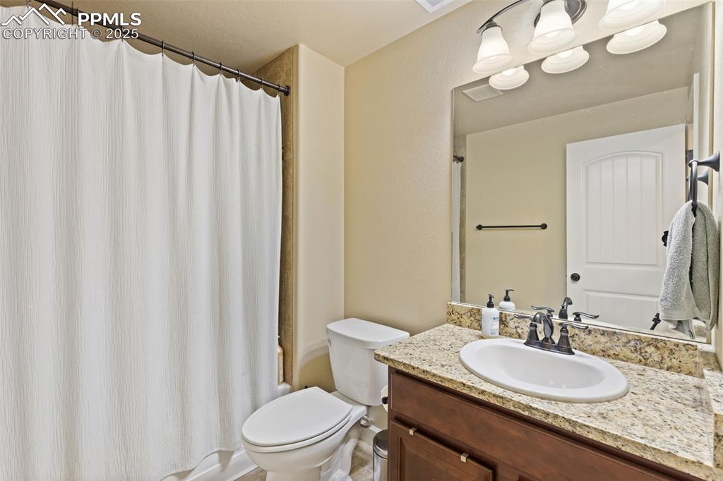 Image 30 of 31: Full bathroom featuring vanity and shower / bath combo
