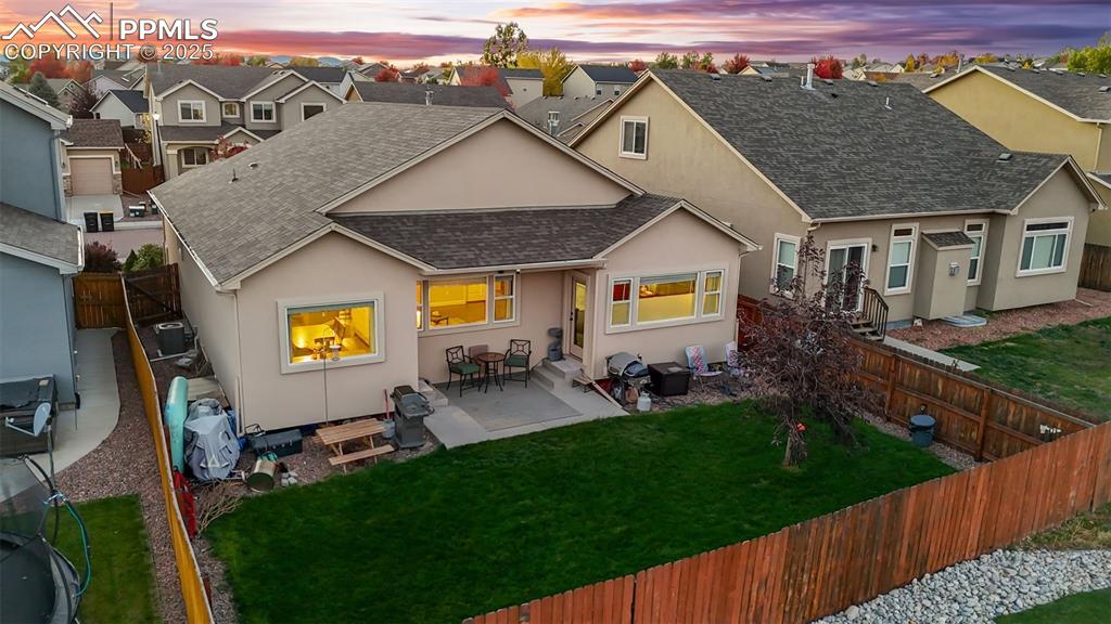 Image 5 of 31: Rear view of house with roof with shingles, a fenced backyard, stucco sidin