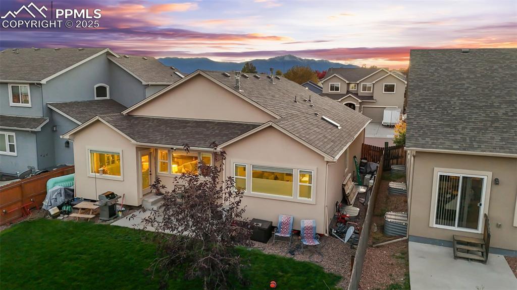Image 6 of 31: Back of property with roof with shingles, a patio area, and entry steps