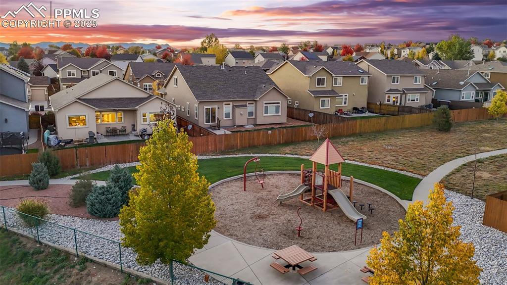 Image 7 of 31: Fenced backyard featuring a playground and a residential view