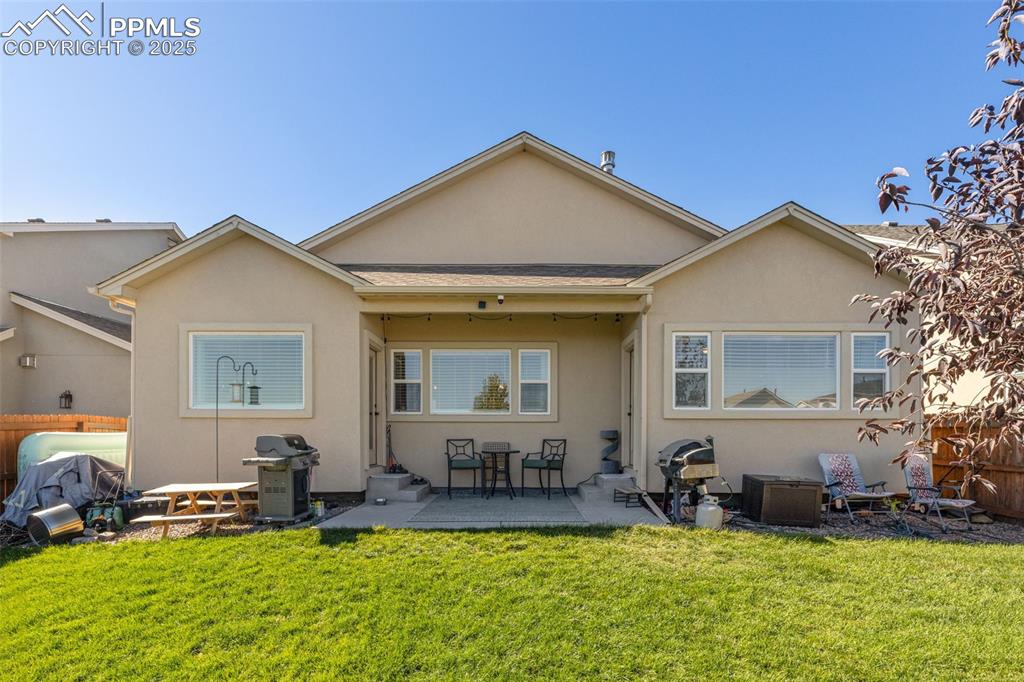 Image 8 of 31: Back of house with stucco siding, a patio, and roof with shingles