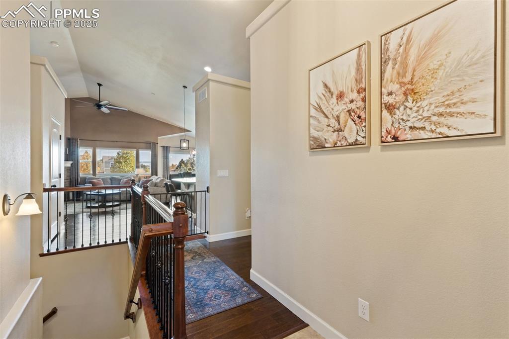 Image 9 of 31: Hall featuring an upstairs landing, dark wood-type flooring, and lofted cei