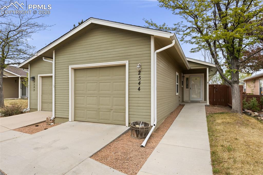 Image 1 of 20: The property features a light green exterior with white trim and a white fr