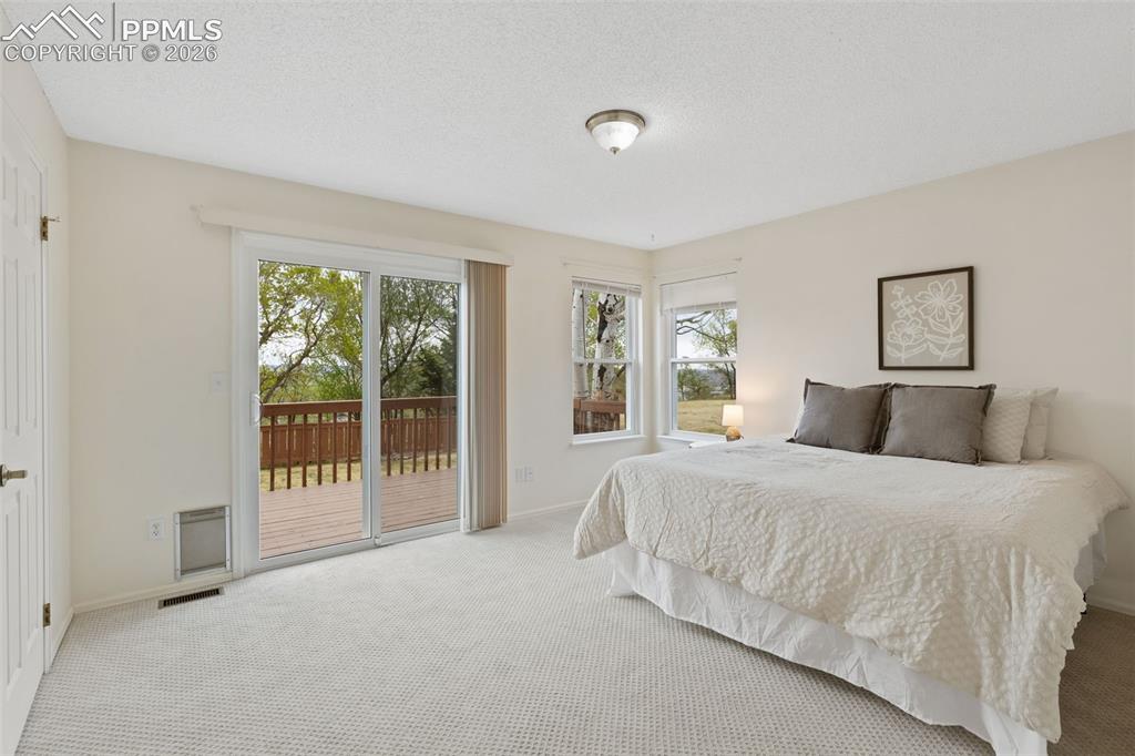 Image 11 of 27: Spacious room featuring light-colored carpet flooring, a ceiling-mounted li