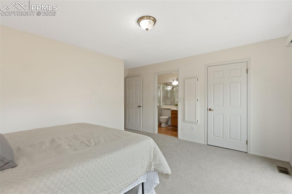 Image 12 of 27: Bedroom featuring carpeted flooring, light-colored walls, and a ceiling-mou