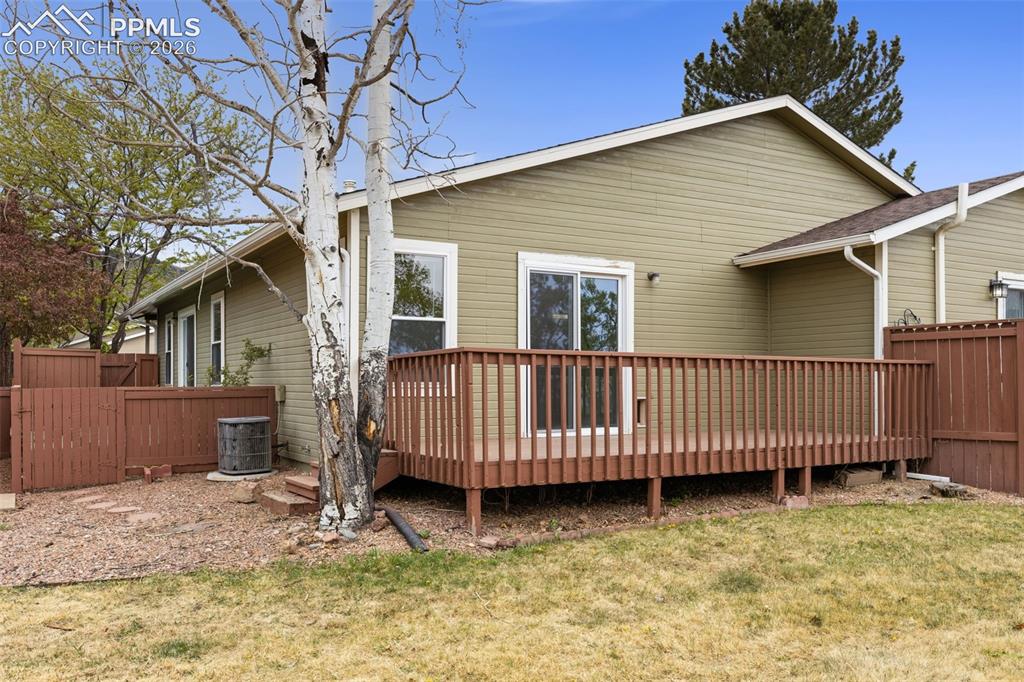 Image 15 of 27: The property features a spacious wooden deck with railings, accessible via