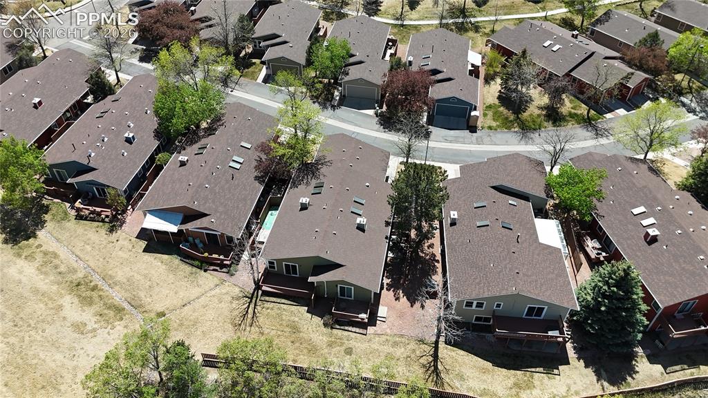 Image 18 of 27: Aerial view of the property and its surrounding neighborhood, featuring res