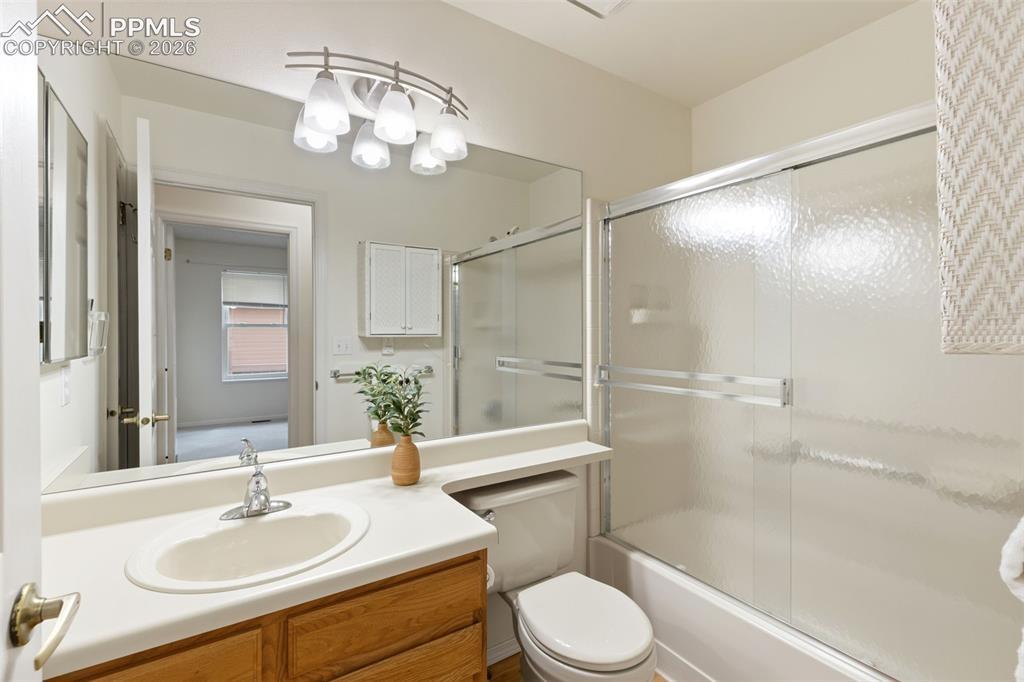 Image 9 of 27: The bathroom features a vanity with a white countertop and a built-in sink,