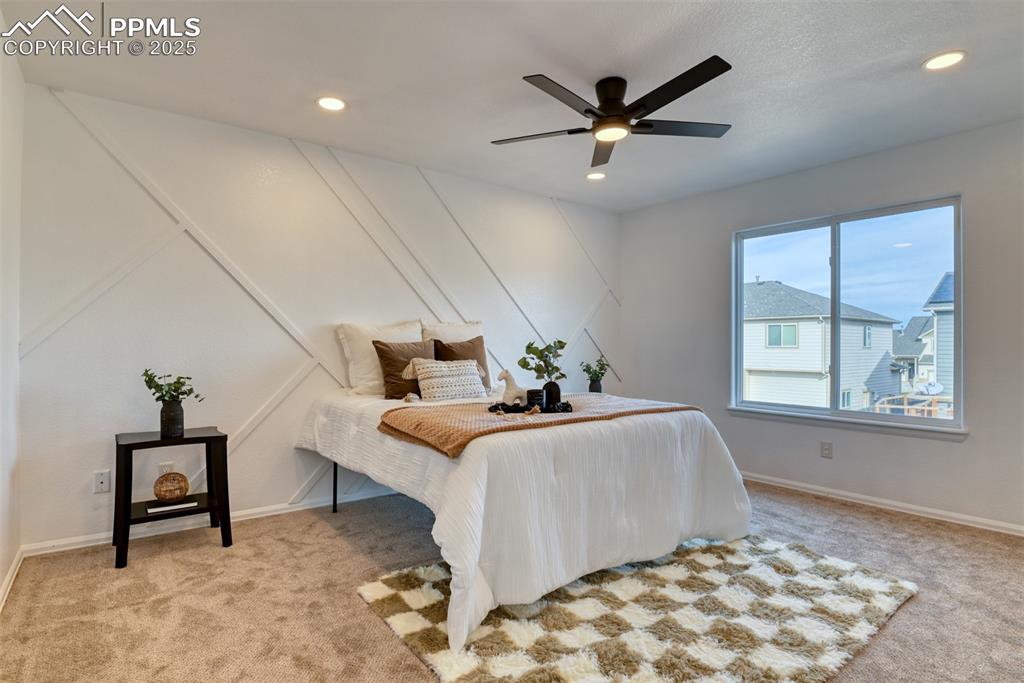 Image 18 of 45: Carpeted bedroom with a ceiling fan and recessed lighting