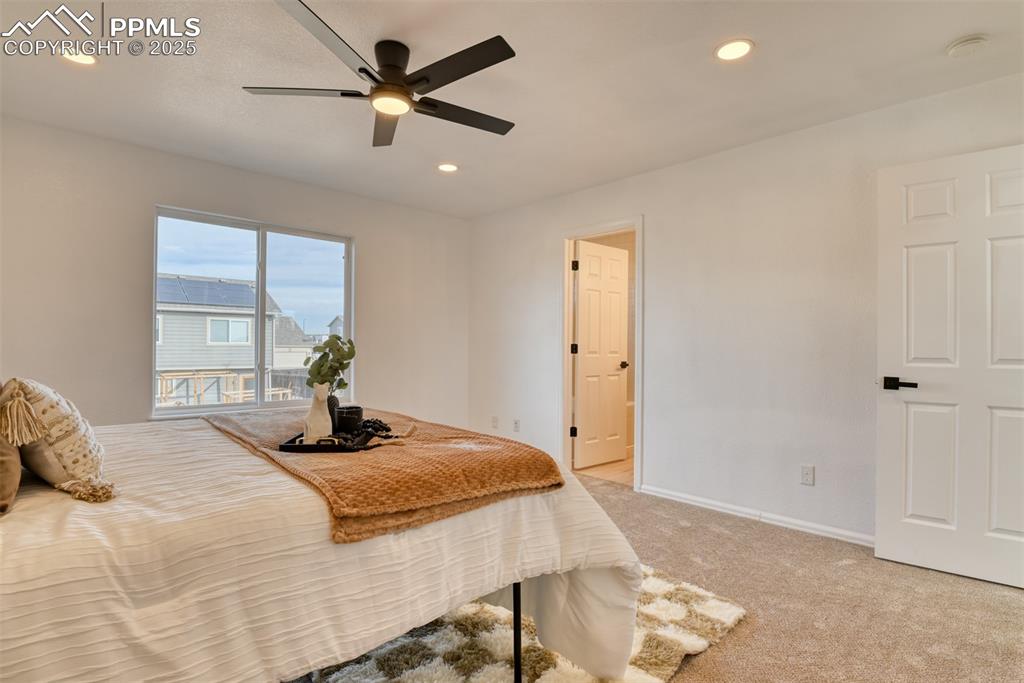 Image 19 of 45: Bedroom featuring light colored carpet, recessed lighting, and a ceiling fa