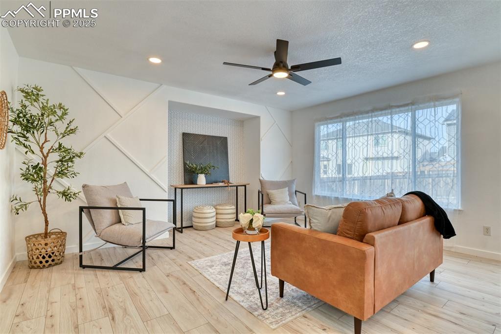 Image 3 of 45: Living area featuring light wood-style floors, ceiling fan, recessed lighti