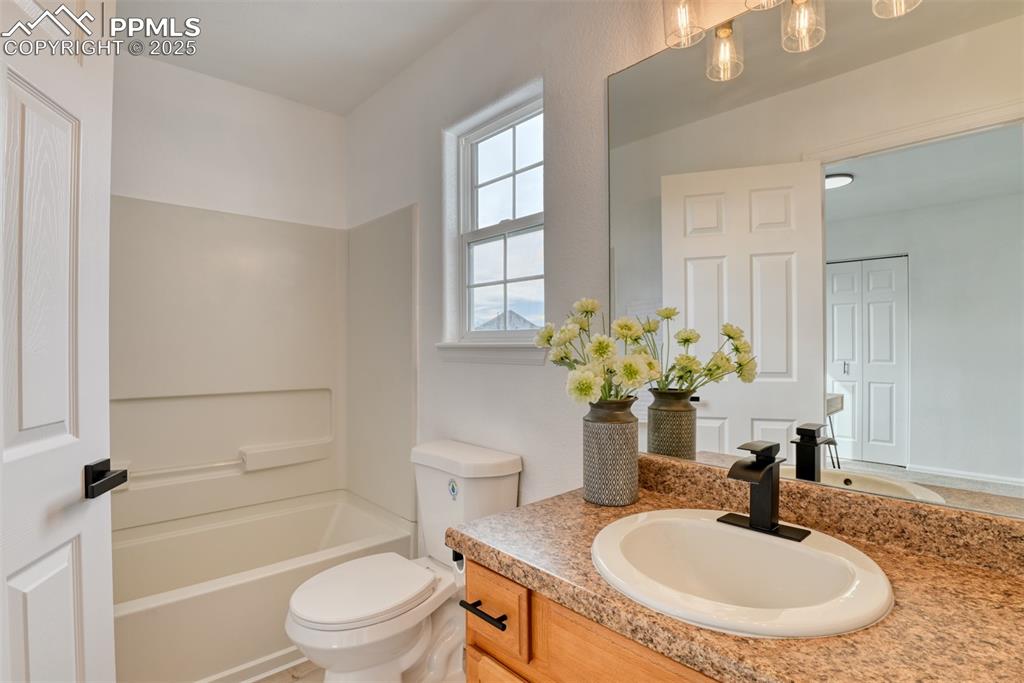 Image 30 of 45: Full bathroom with vanity and tub / shower combination