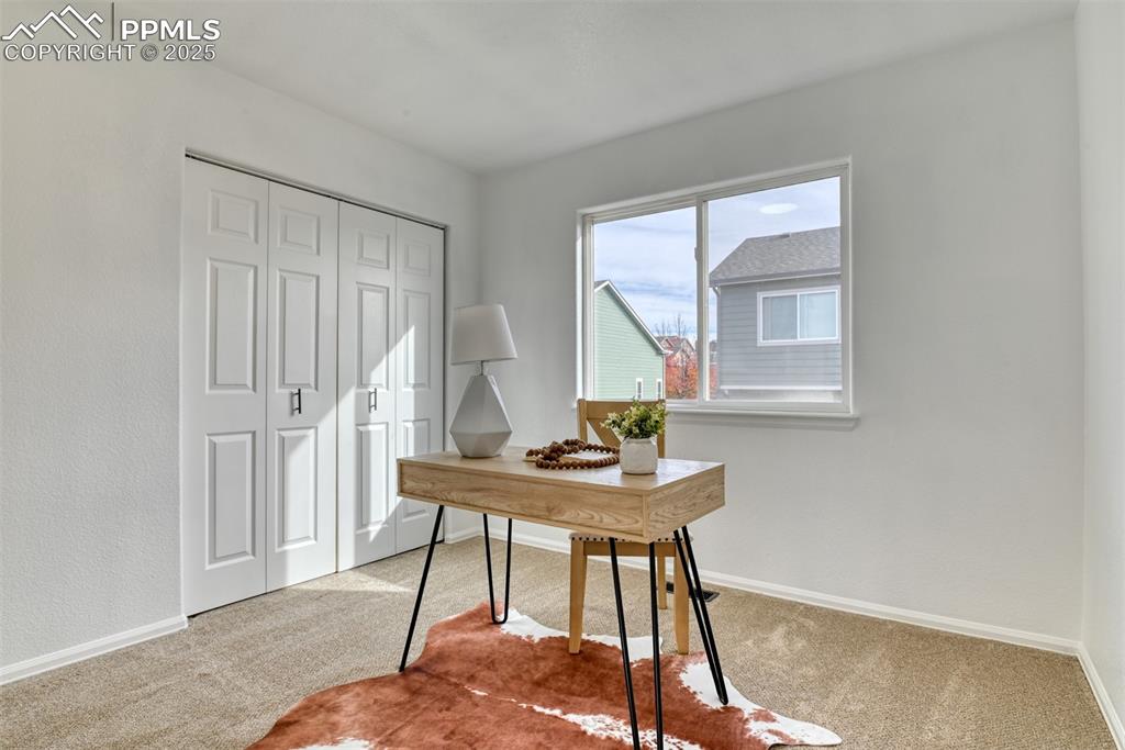 Image 33 of 45: Home office with carpet floors