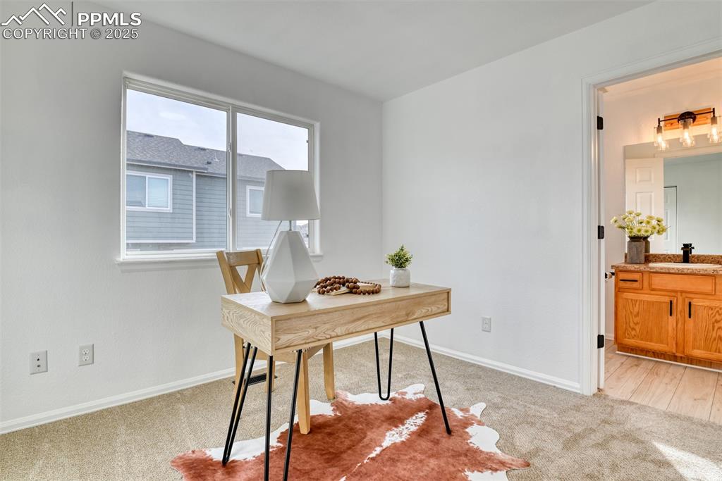Image 35 of 45: Office area with light carpet and baseboards