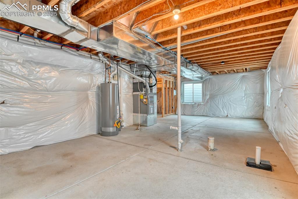 Image 40 of 45: Basement featuring water heater and heating unit