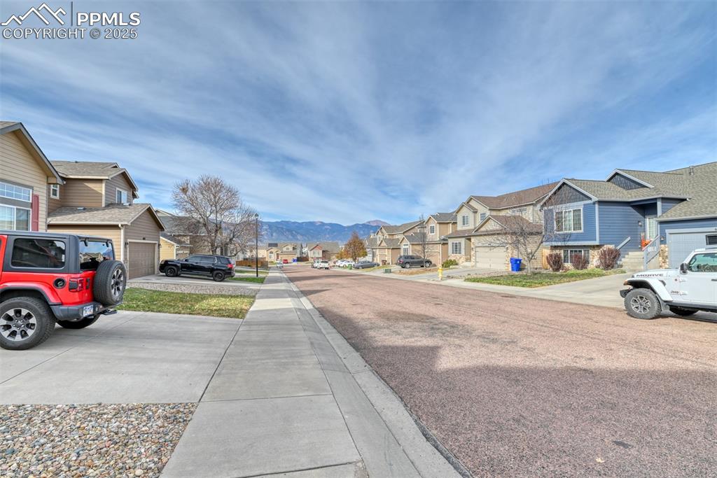 Image 41 of 45: View of asphalt street with a residential view and a mountain view