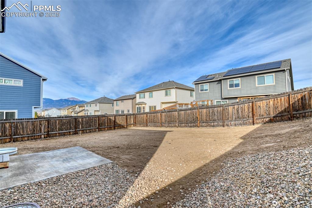 Image 42 of 45: Fenced backyard featuring a residential view and a patio area